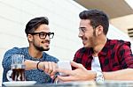 Two Young Entrepreneurs Working At Coffee Shop Stock Photo