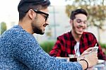 Two Young Entrepreneurs Working At Coffee Shop Stock Photo