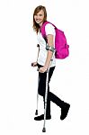 University Student Walking With Help Of Crutches Stock Photo