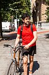 Urban Athlete Walking His Bike Through A City Stock Photo