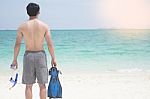 Vacation Backside Of Man Holding Snorkeling Gear On Tropical On Stock Photo