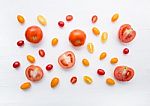 Variety Tomatoes On White Wooden Background Stock Photo