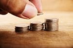 Vintage Close Up Of Hand Stacking Silver Coins Stock Photo