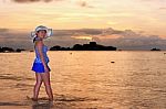 Visitors Woman Looking The Sunrise Over The Sea Stock Photo