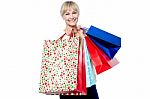 Vivacious Woman Holding Colorful Shopping Bags Stock Photo