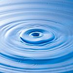 Water Drop Impact With Water Surface, Causing Rings On The Surface Stock Photo