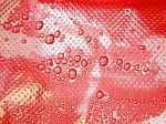 Water Drops On A Red Background Stock Photo