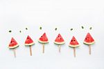 Watermelon Slice Popsicles And Paper Mint On White Wooden Backgr Stock Photo