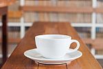 White Coffee Cup On Wooden Table Stock Photo