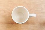 White Cup Top View On Wooden Table Stock Photo