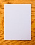 White Paper On Wood Table Stock Photo