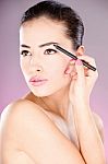 Woman Applying Cosmetic Pencil Stock Photo