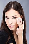 Woman Applying Make Up On Her Cheek Stock Photo