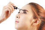 Woman Applying Mascara Stock Photo