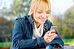 Woman At Park Taking A Phone Call Stock Photo