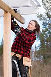 Woman Working With A Drilling Machine Stock Photo