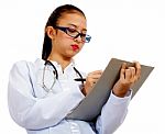 Woman Doctor Writing A Report Stock Photo