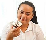 Woman Eating A Donut Stock Photo