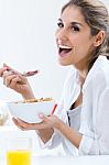 Woman Eating Cereals In The Morning Stock Photo