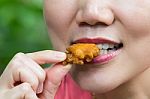 Woman Eating Chicken Stock Photo