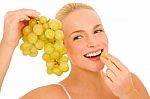 Woman Eating Grapes Stock Photo