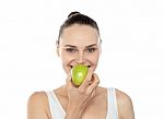 Woman Eating Green Apple Stock Photo