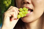 Woman Eating Green Grapes Friut Stock Photo