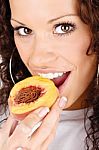 Woman Eating Peach Stock Photo