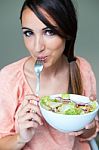 Woman Eating Salad. Portrait Of Beautiful Smiling And Happy Cauc Stock Photo