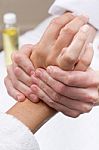 Woman Enjoying Hand Massage At Beauty Spa Stock Photo