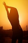 Woman Exercising Outdoor At Sunset  Stock Photo