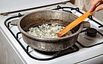 Woman Frying Onions Stock Photo