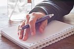 Woman Hand With Pen Writing On Notebook Stock Photo