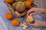 Woman Hands Peeling A Mandarin Stock Photo