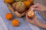 Woman Hands Peeling A Mandarin Stock Photo