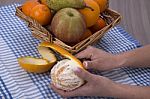 Woman Hands Peeling An Orange With A Knife Stock Photo