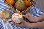 Woman Hands Peeling An Orange With A Knife Stock Photo