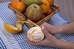 Woman Hands Peeling An Orange With A Knife Stock Photo