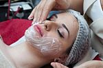 Woman Having Facial Mask At Beauty Salon Stock Photo