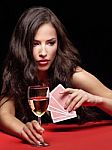 Woman Holding Gambling Cards And Wine Stock Photo