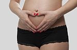 Woman Holding Her Pregnant Belly. White Background Stock Photo