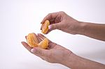 Woman Holding Slices Of Mandarin Stock Photo