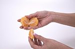 Woman Holding Slices Of Mandarin Stock Photo