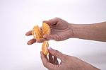 Woman Holding Slices Of Mandarin Stock Photo