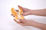 Woman Holding Slices Of Orange Stock Photo