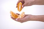 Woman Holding Slices Of Orange Stock Photo