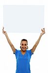 Woman Holding Up Blank White Ad Board Stock Photo