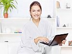 Woman In Bathrobe With Computer Stock Photo