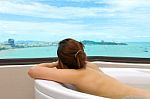 Woman In Bathtub Relaxing Sea View Background Stock Photo