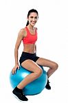 Woman In Gym Exercising With Pilates Ball Stock Photo